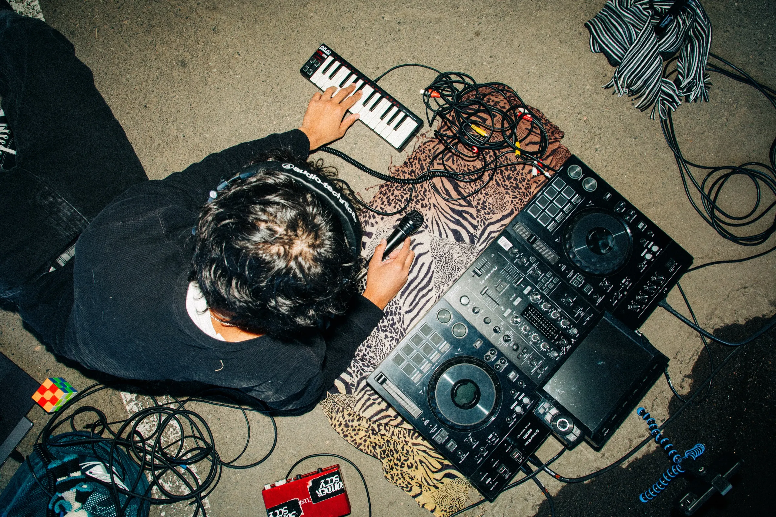 phaseeluv over a dj rig laid out on pavement, shot from above