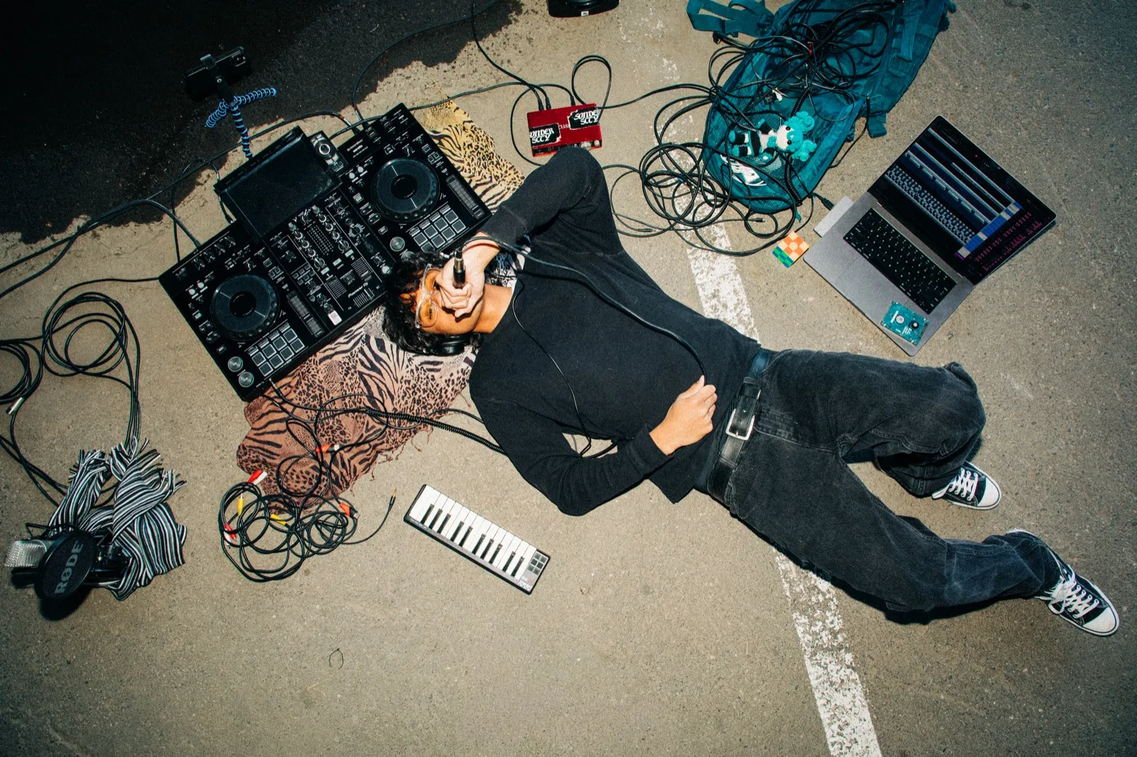 phaseeluv laid out over a dj rig on pavement, flash overhead shot